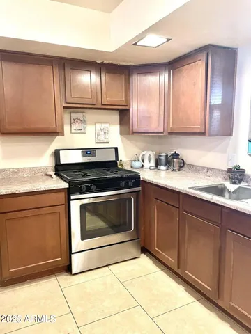 a kitchen with sink cabinets and window