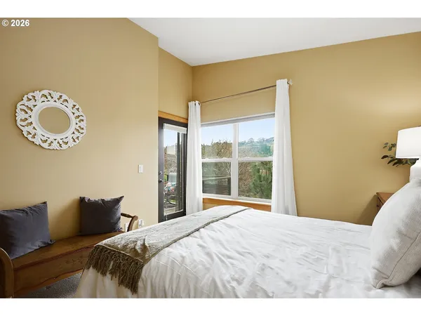 a bedroom with a bed and painting on the wall