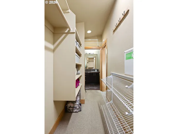 a bedroom with a bed window and a chair