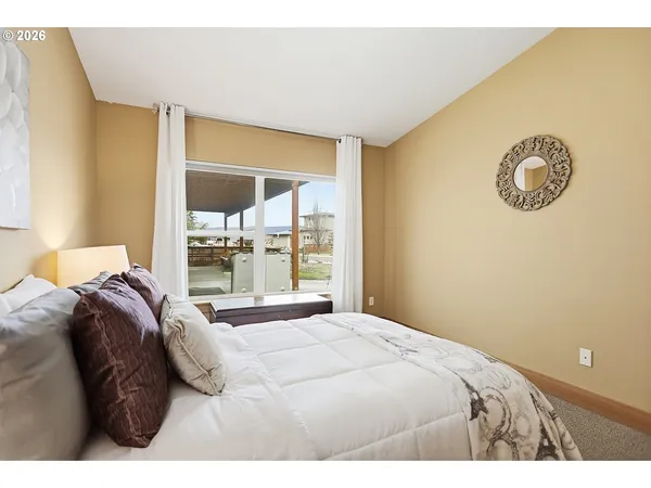 a bedroom with a bed and a wall painting