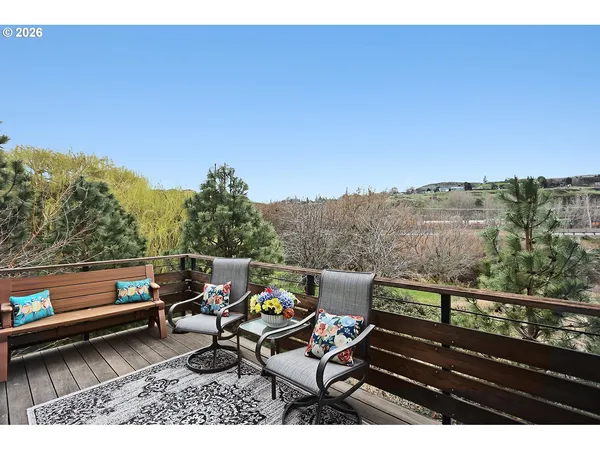 a view of a terrace with lawn chairs and wooden floor