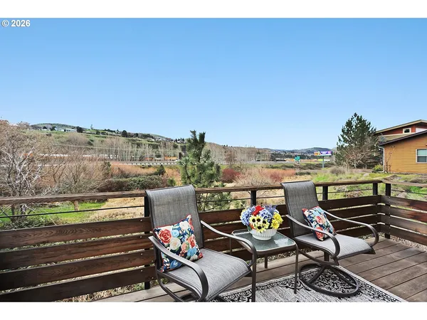 a backyard of a house with table and chairs