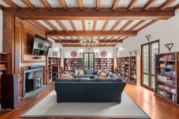 a living room with lots of furniture and a fireplace