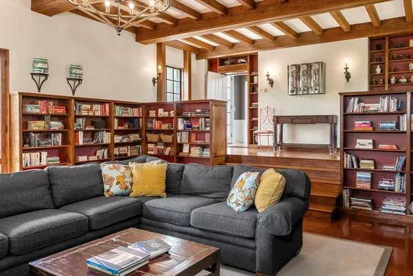 a living room with furniture and painting on the wall