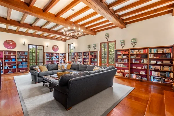 a living room with lots of furniture and a book shelf