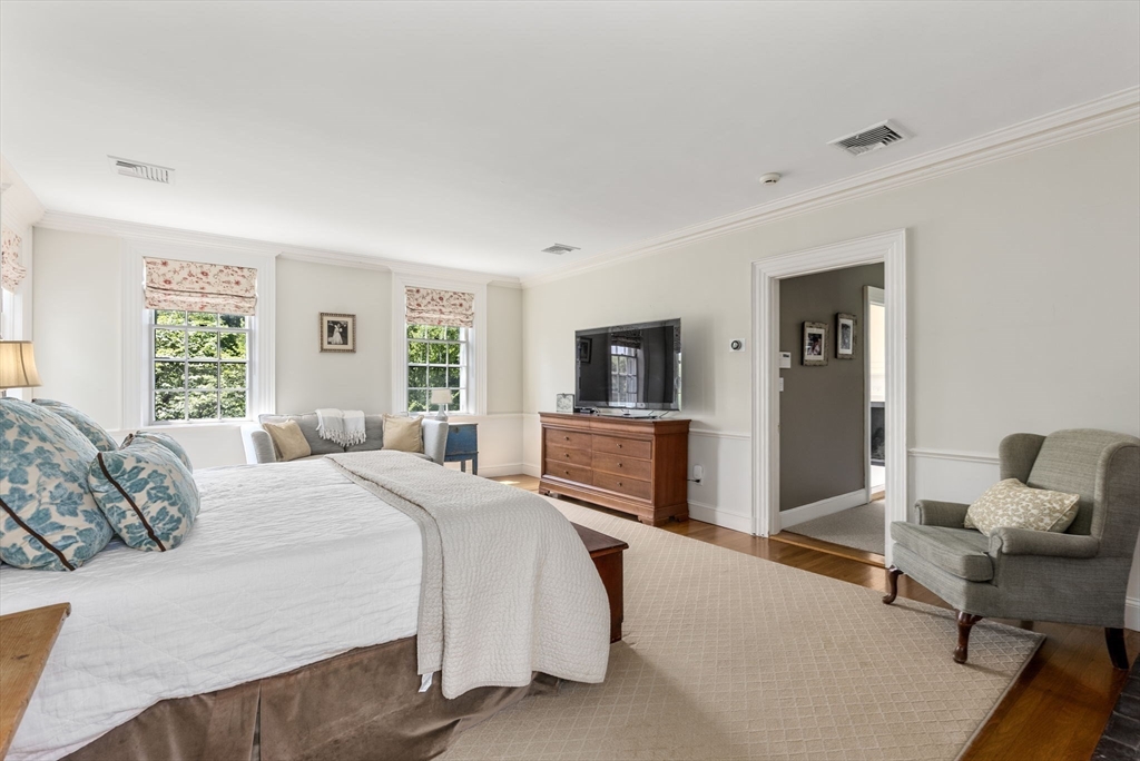 427 Concord Road Sudbury, MA 01776 - Photo 24 of 42 a bedroom with a bed and a flat screen tv