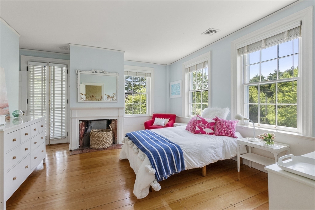 427 Concord Road Sudbury, MA 01776 - Photo 29 of 42 a bedroom with a bed and wooden floor