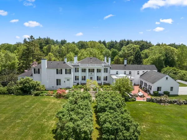 a aerial view of a house with garden space and a street view