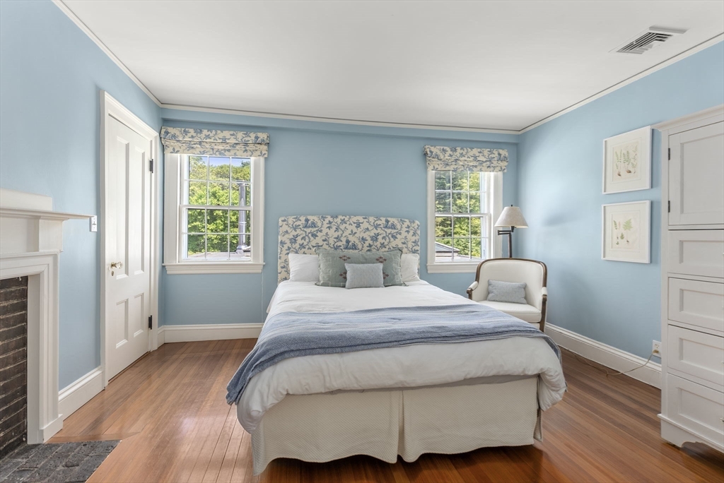 427 Concord Road Sudbury, MA 01776 - Photo 31 of 42 a bedroom with a bed and wooden floor