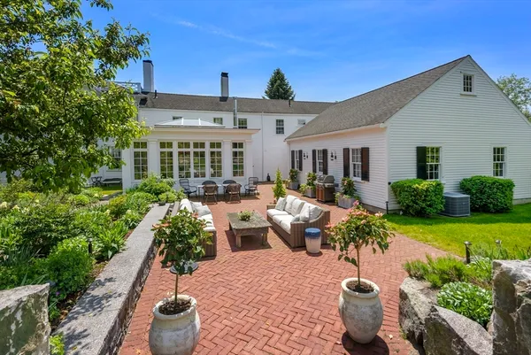 a view of a patio with chairs and potted plants