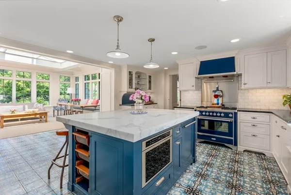 a kitchen with stainless steel appliances granite countertop a stove and a refrigerator