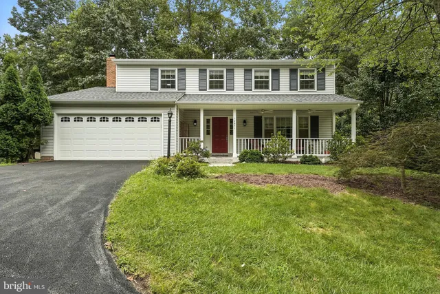 a front view of a house with yard and green space
