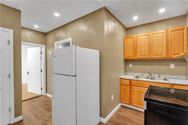 a kitchen with a refrigerator and a sink