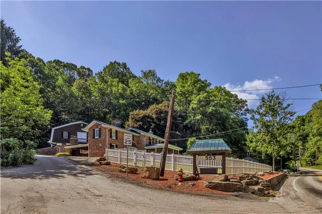 a aerial view of a house with a yard and balcony