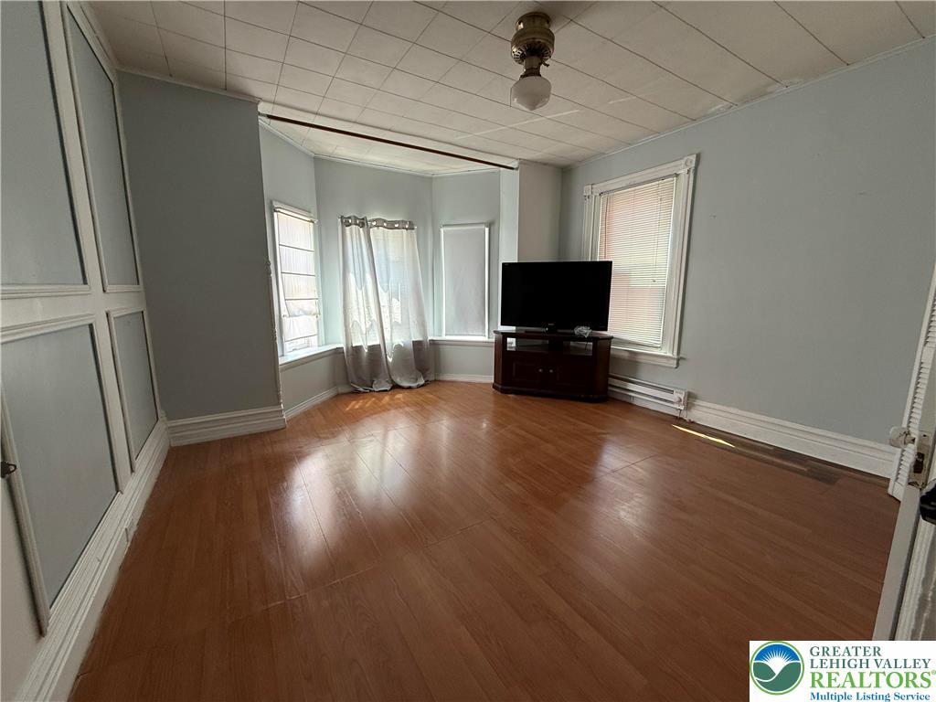 445 Washington Street Allentown, PA 18102 - Photo 14 of 27 an empty room with wooden floor and windows