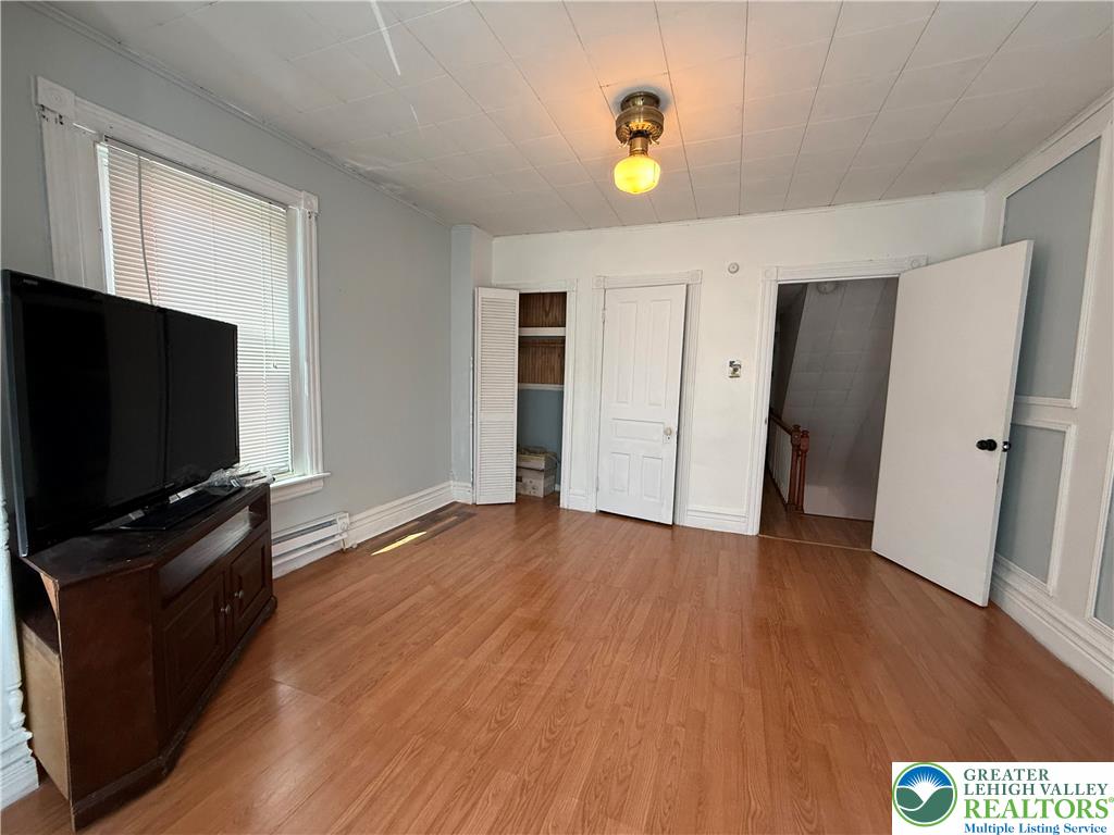 445 Washington Street Allentown, PA 18102 - Photo 15 of 27 a view of a livingroom with wooden floor and a flat screen tv