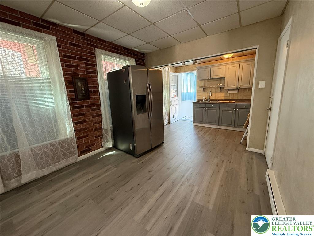 445 Washington Street Allentown, PA 18102 - Photo 6 of 27 a view of a refrigerator in kitchen and wooden floor