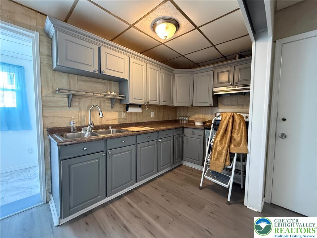 445 Washington Street Allentown, PA 18102 - Photo 8 of 27 a kitchen with wooden cabinets and sink