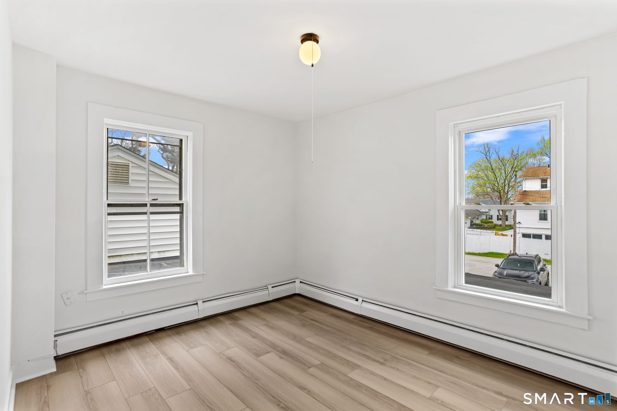 63 Reynolds Street, Unit B Killingly, CT 06239 - Photo 11 of 32 a view of an empty room with window and wooden floor
