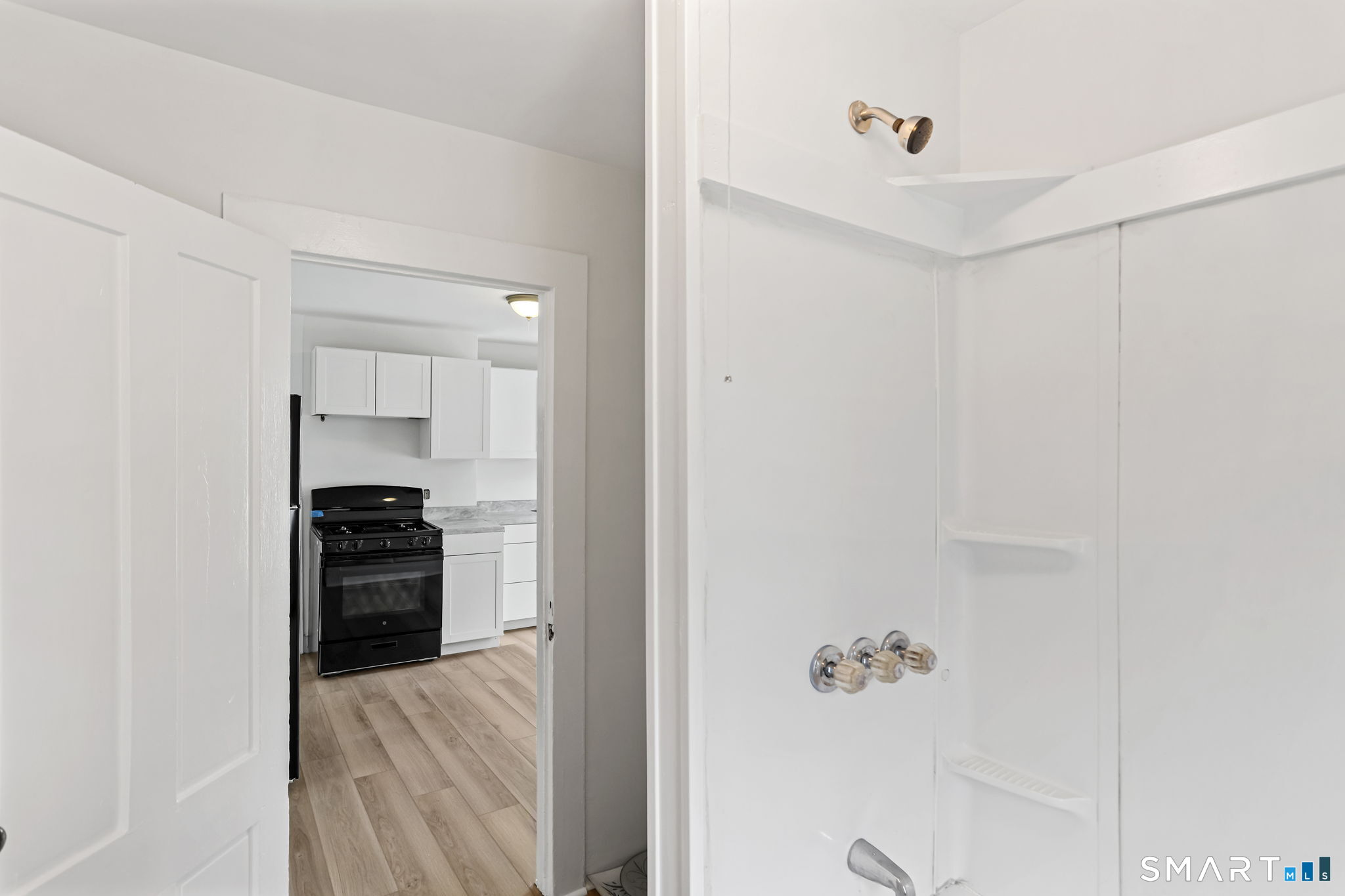 63 Reynolds Street, Unit B Killingly, CT 06239 - Photo 12 of 32 a kitchen with a refrigerator and a stove