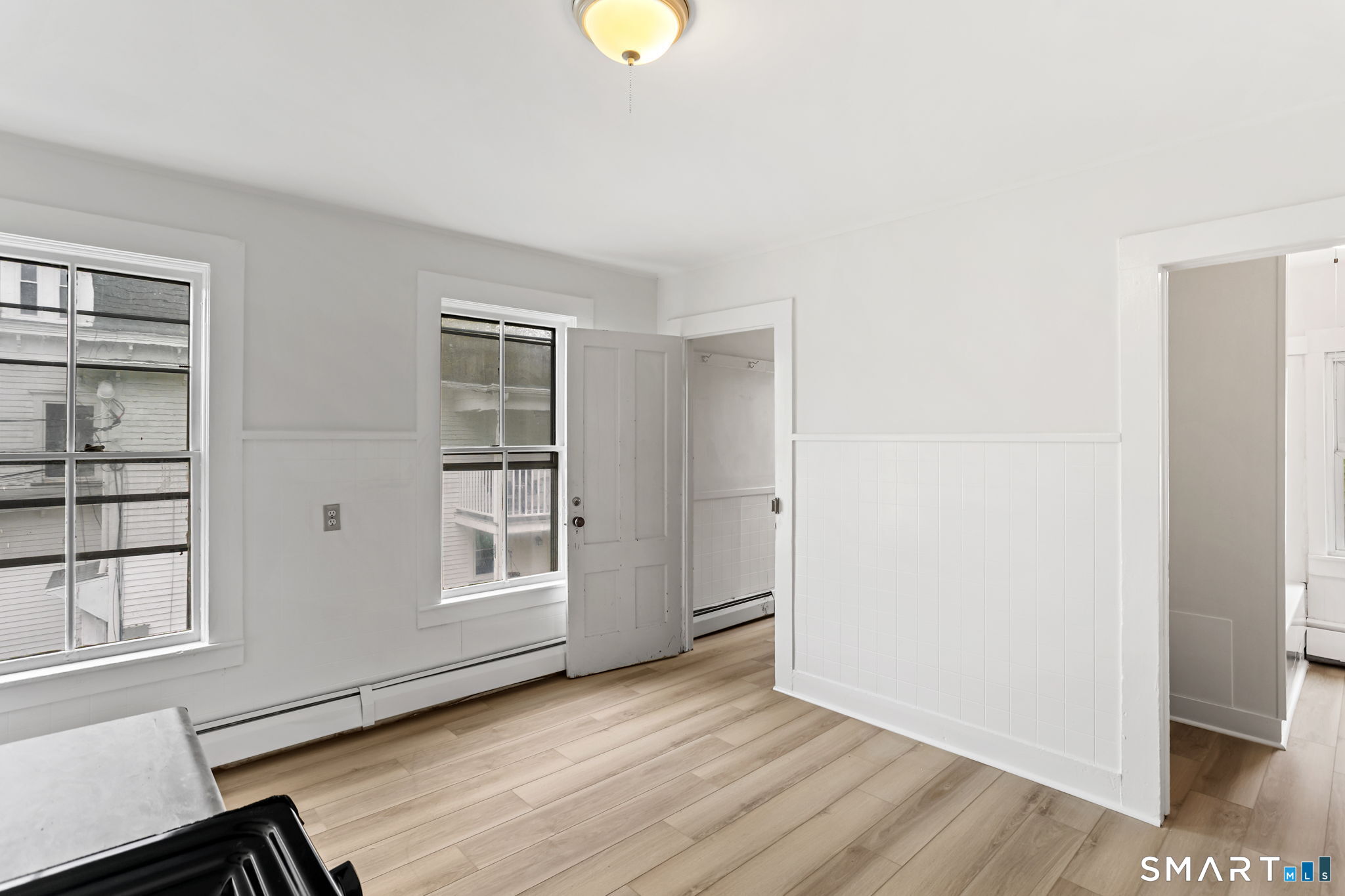 63 Reynolds Street, Unit B Killingly, CT 06239 - Photo 19 of 32 a view of an empty room with wooden floor and a window