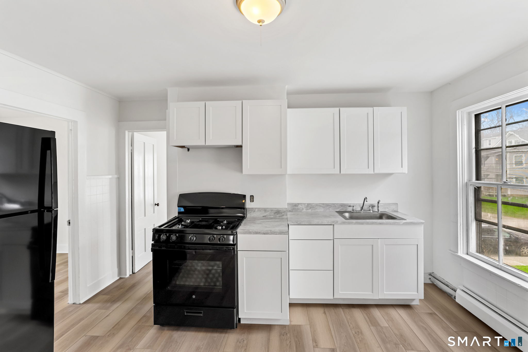 63 Reynolds Street, Unit B Killingly, CT 06239 - Photo 21 of 32 a kitchen with a sink and a stove top oven