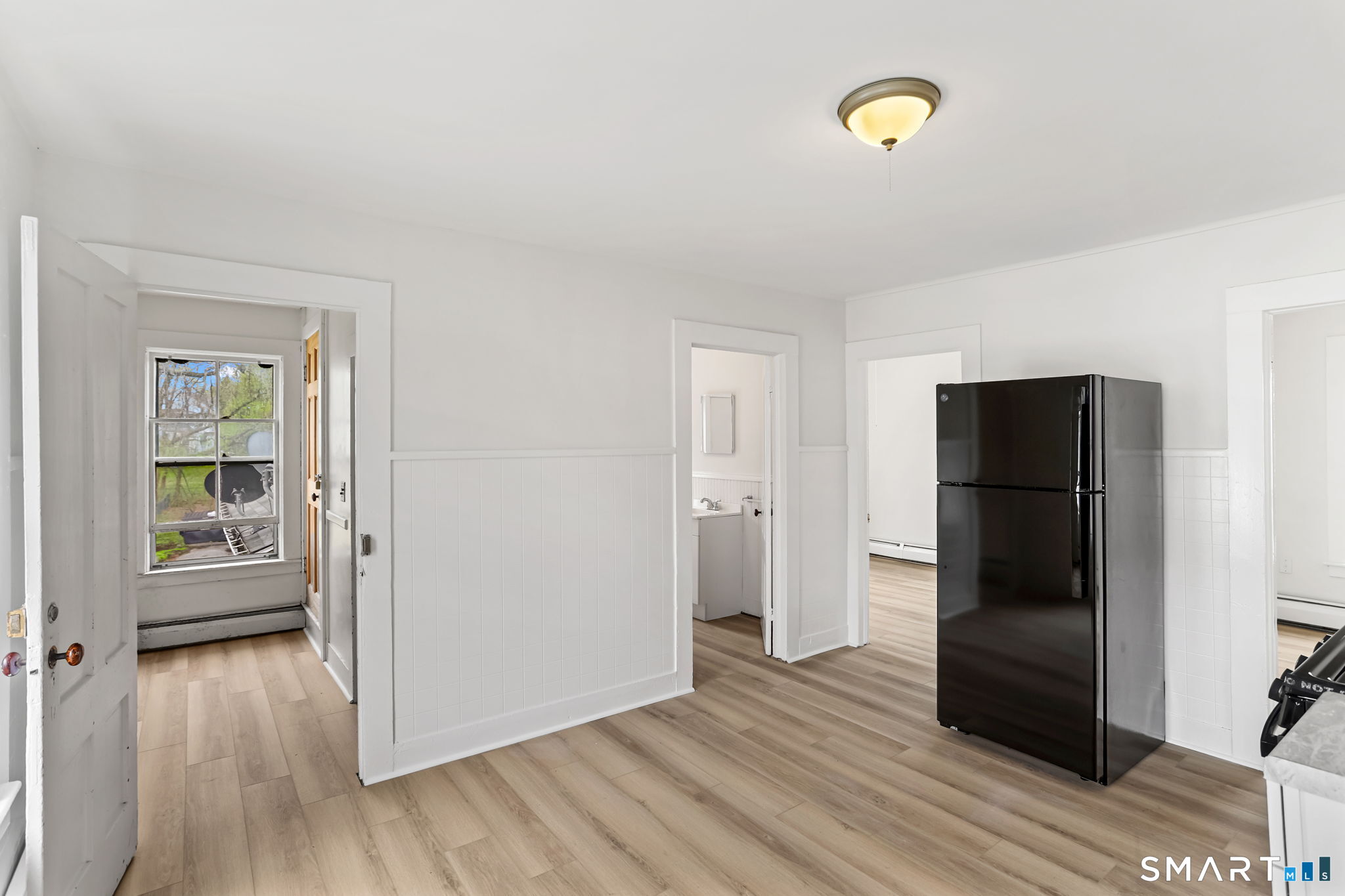 63 Reynolds Street, Unit B Killingly, CT 06239 - Photo 23 of 32 a view of an empty room with wooden floor and a window
