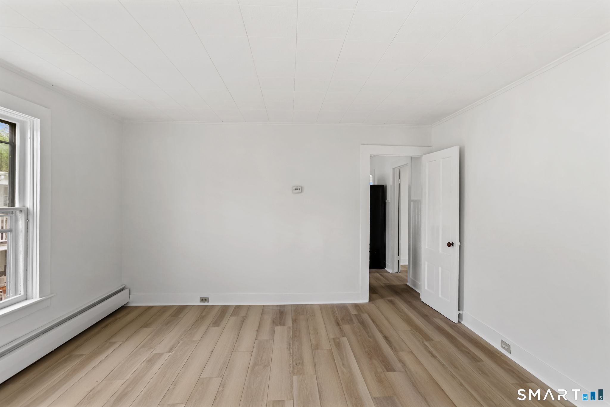 63 Reynolds Street, Unit B Killingly, CT 06239 - Photo 24 of 32 a view of an empty room with wooden floor and a window