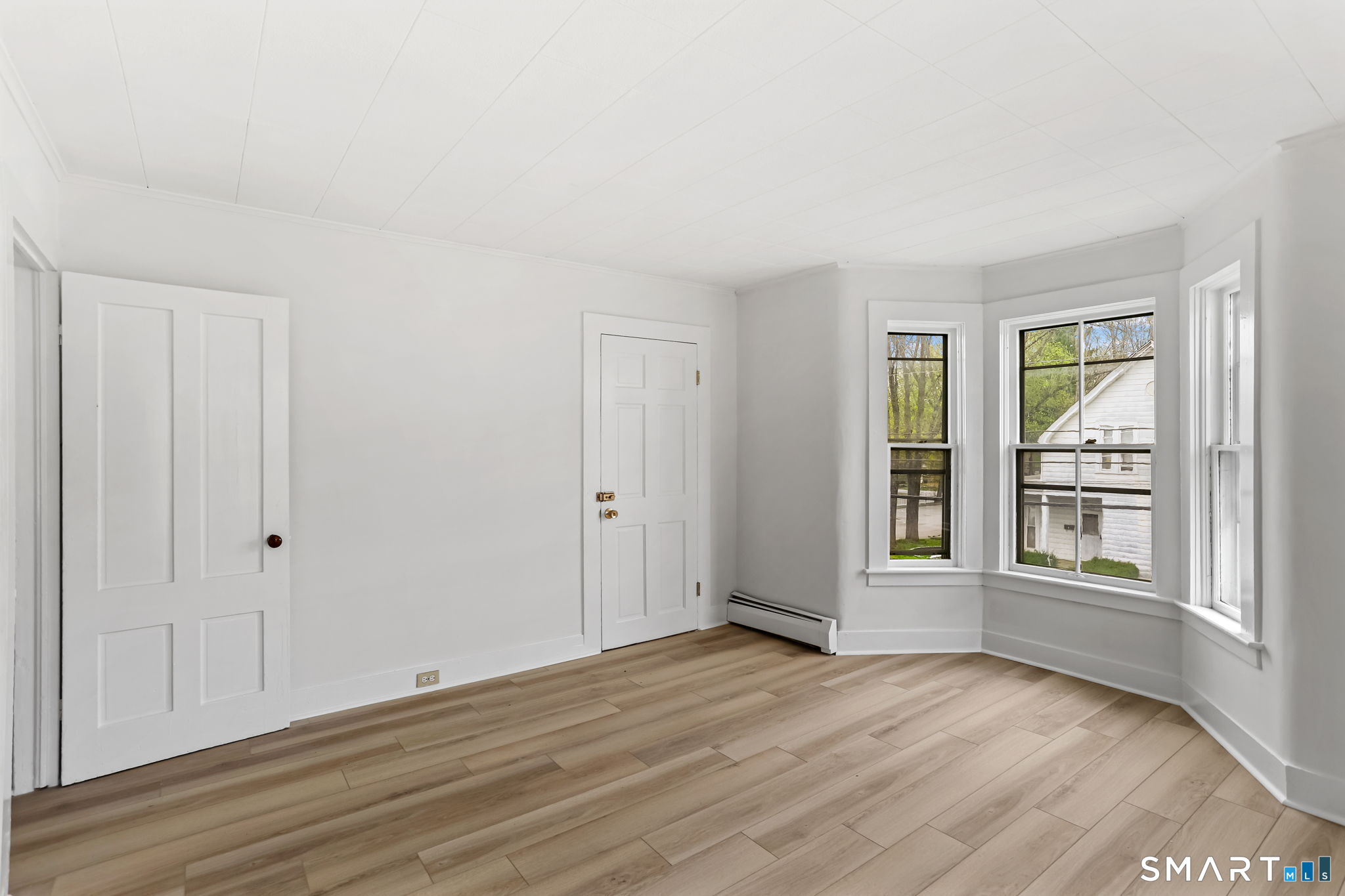 63 Reynolds Street, Unit B Killingly, CT 06239 - Photo 26 of 32 a view of empty room with wooden floor and fan