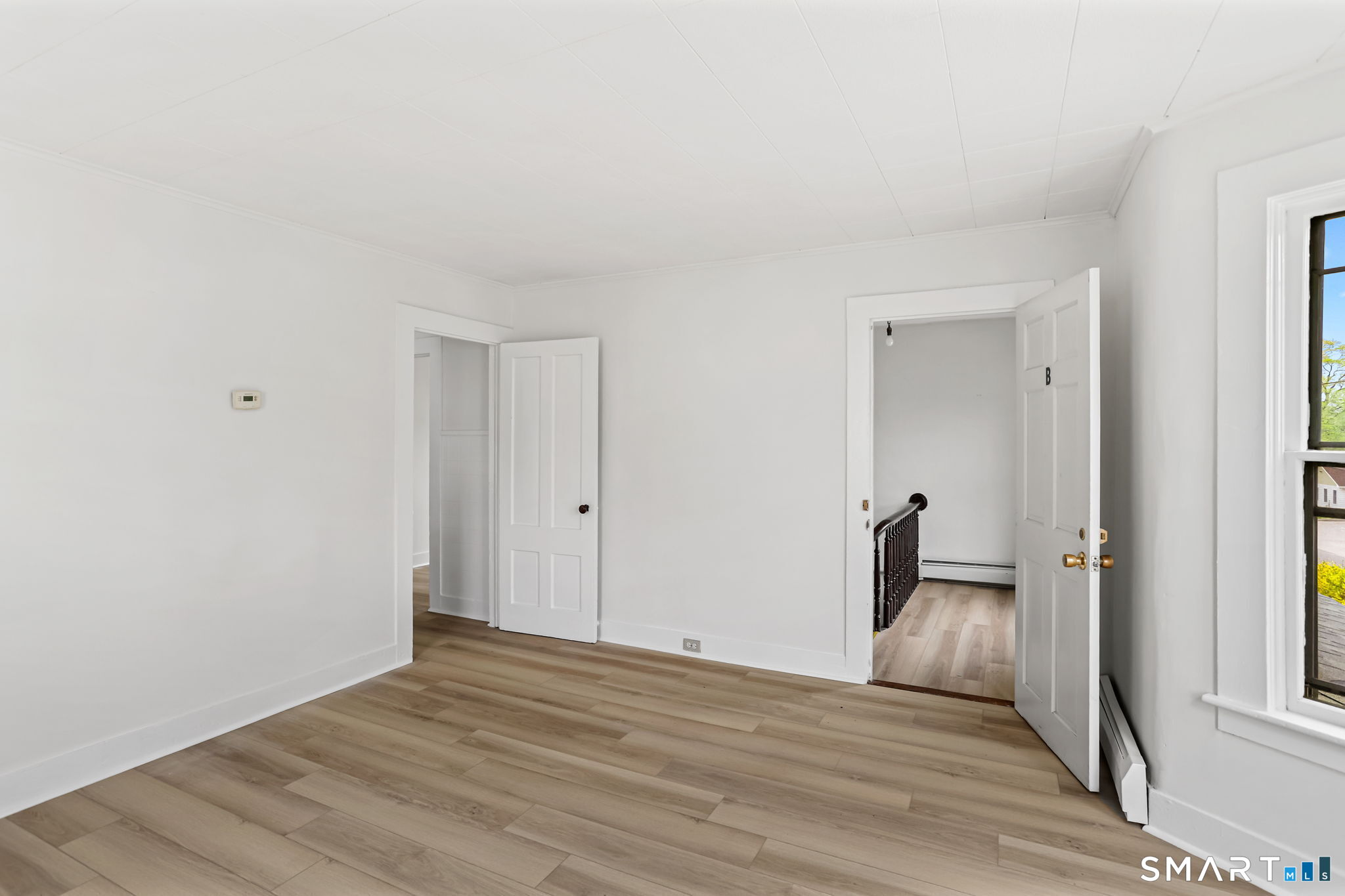 63 Reynolds Street, Unit B Killingly, CT 06239 - Photo 28 of 32 a view of empty room with wooden floor and window