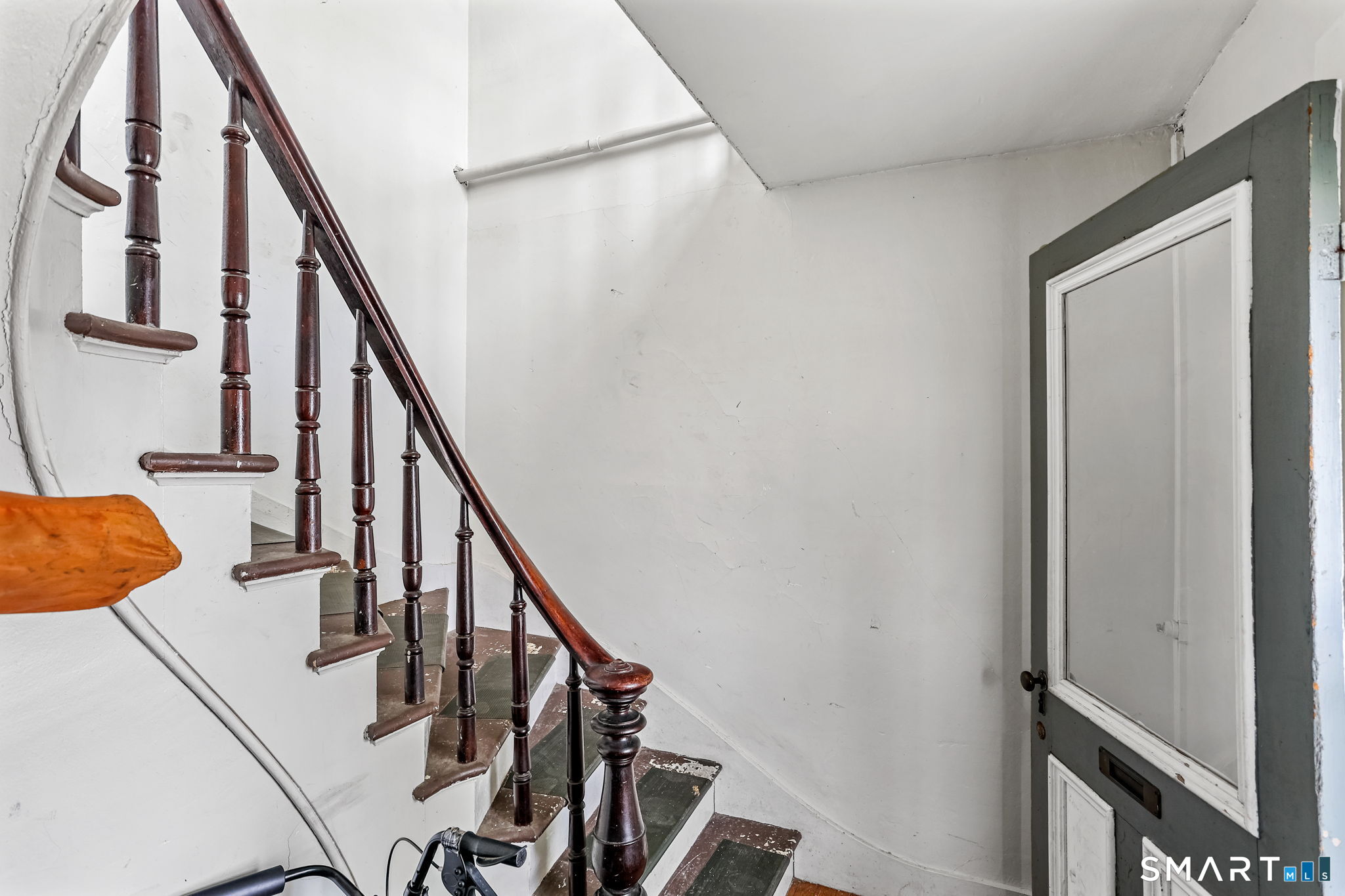 63 Reynolds Street, Unit B Killingly, CT 06239 - Photo 3 of 32 a view of staircase with wooden floor and white walls