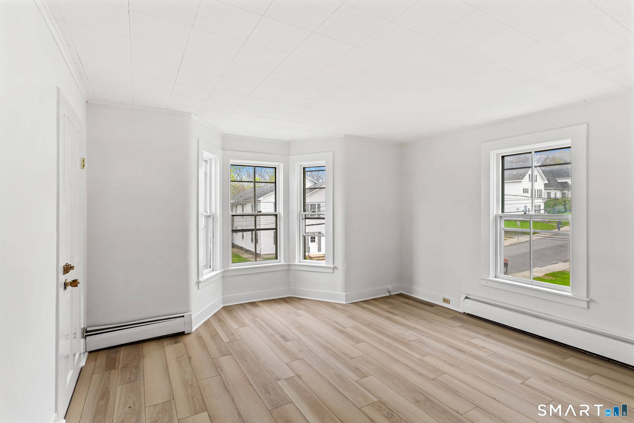 63 Reynolds Street, Unit B Killingly, CT 06239 - Photo 32 of 32 an empty room with wooden floor and windows