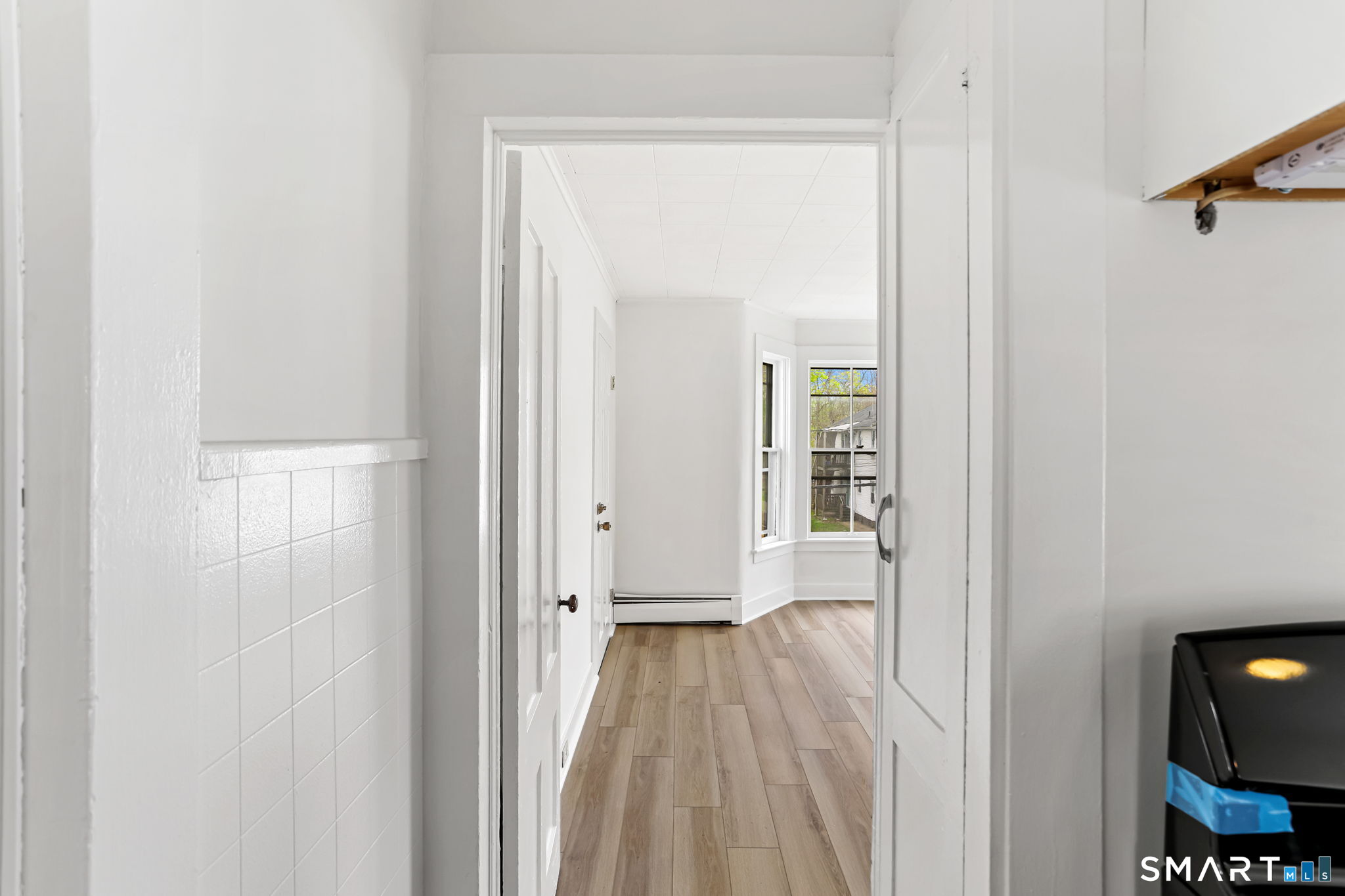 63 Reynolds Street, Unit B Killingly, CT 06239 - Photo 4 of 32 a view of a hallway with wooden floor and a bathroom