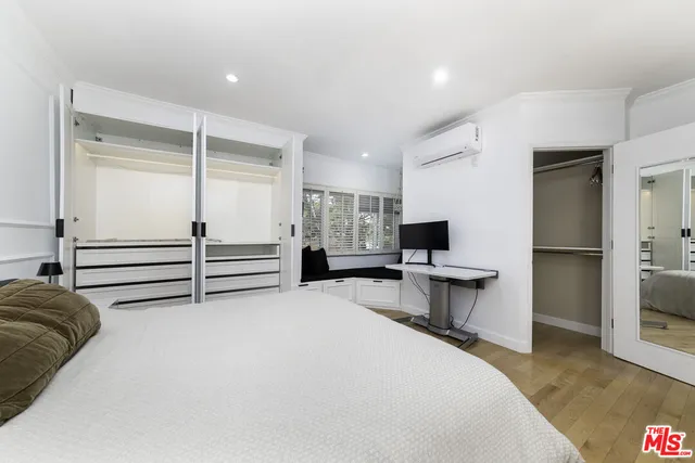 a bedroom with a bed and a television