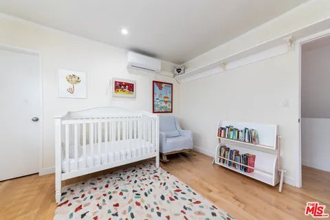 a bedroom with furniture and a wooden floor