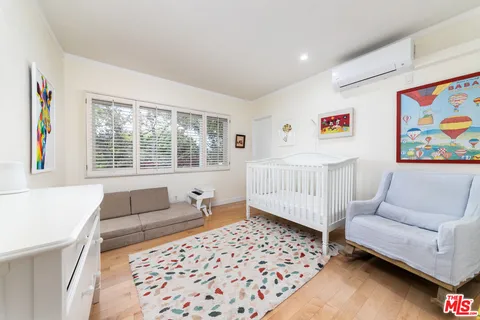 a bedroom with furniture and a window