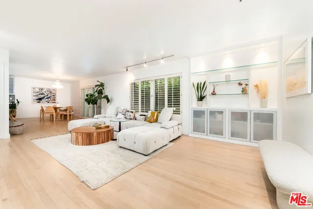 a bedroom with furniture and large windows