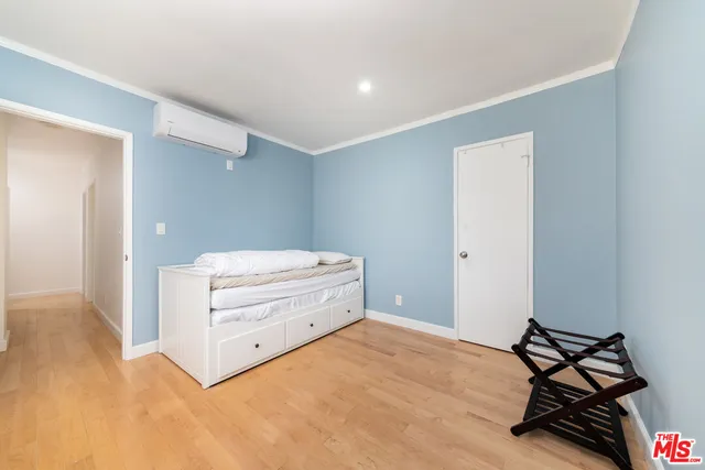 a room with a dresser and a window