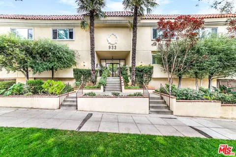 a view of a house with a garden and plants