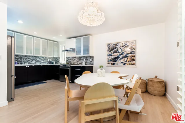 a kitchen with granite countertop white cabinets and stainless steel appliances