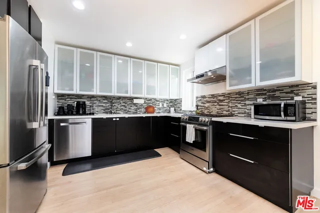 a kitchen with a stove a sink and a refrigerator