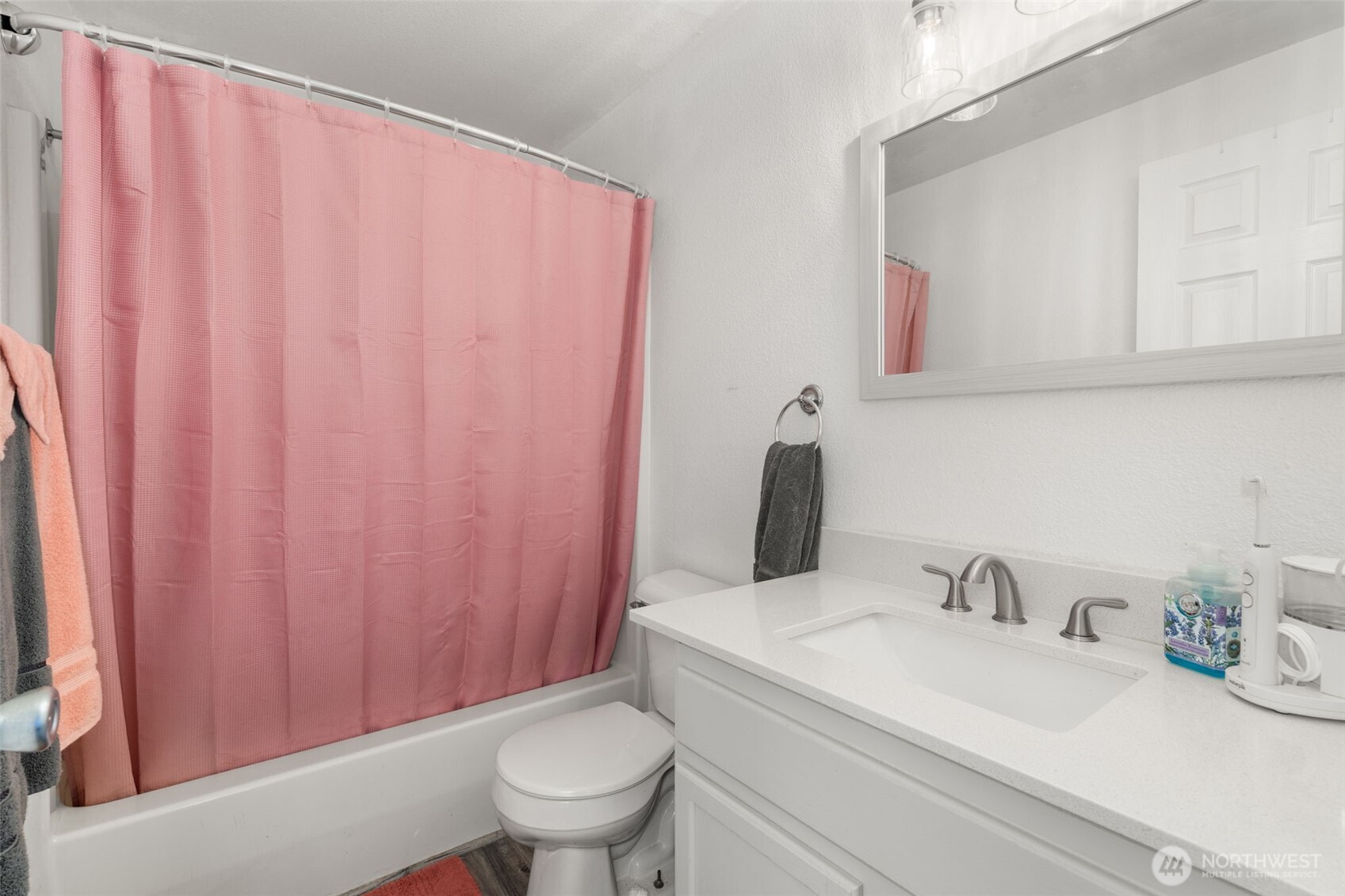 5916 187th Lane Southwest Rochester, WA 98579 - Photo 14 of 39 a bathroom with a sink a toilet and shower curtain