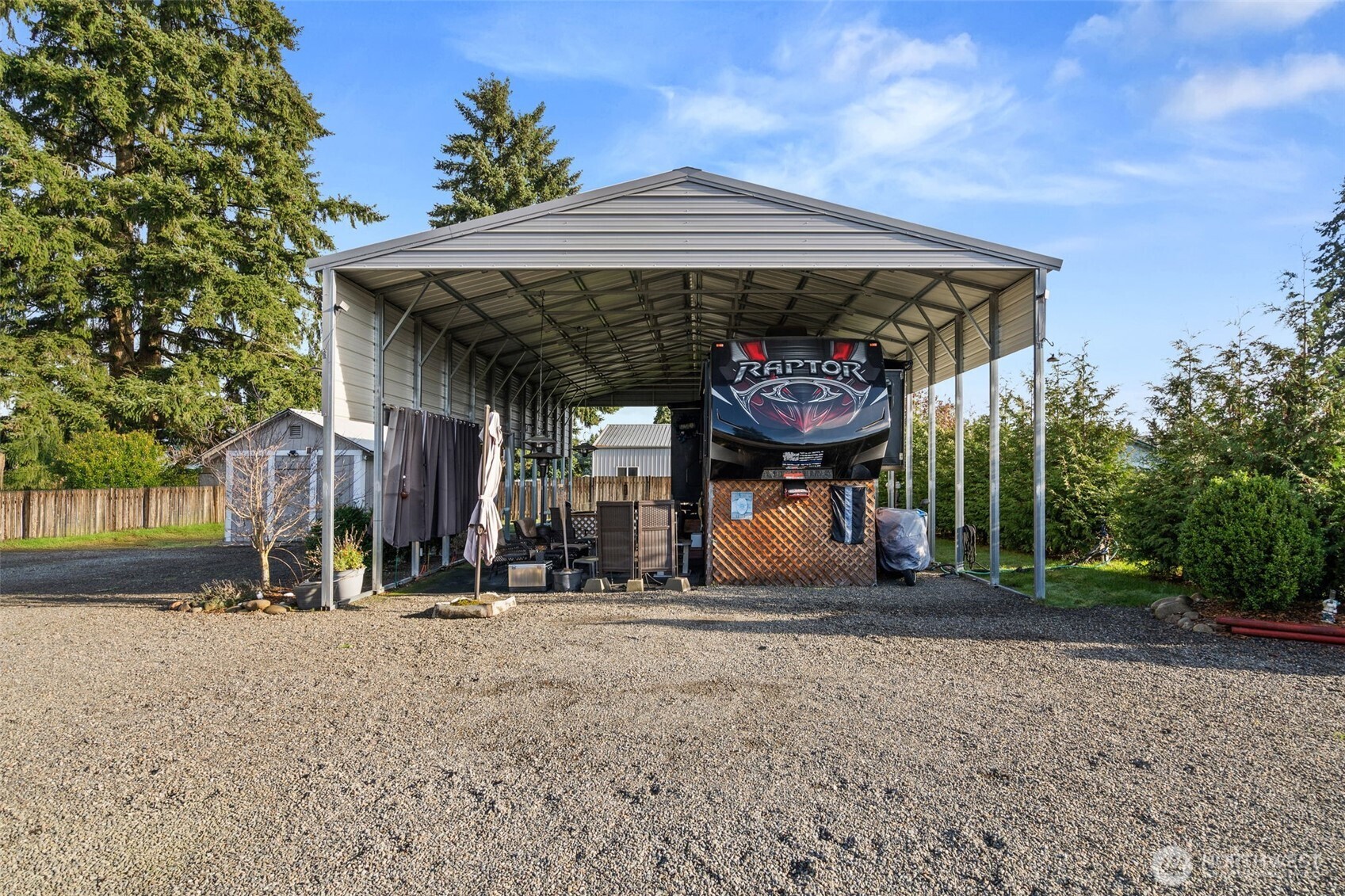 5916 187th Lane Southwest Rochester, WA 98579 - Photo 19 of 39 a view of a chairs and table under an umbrella