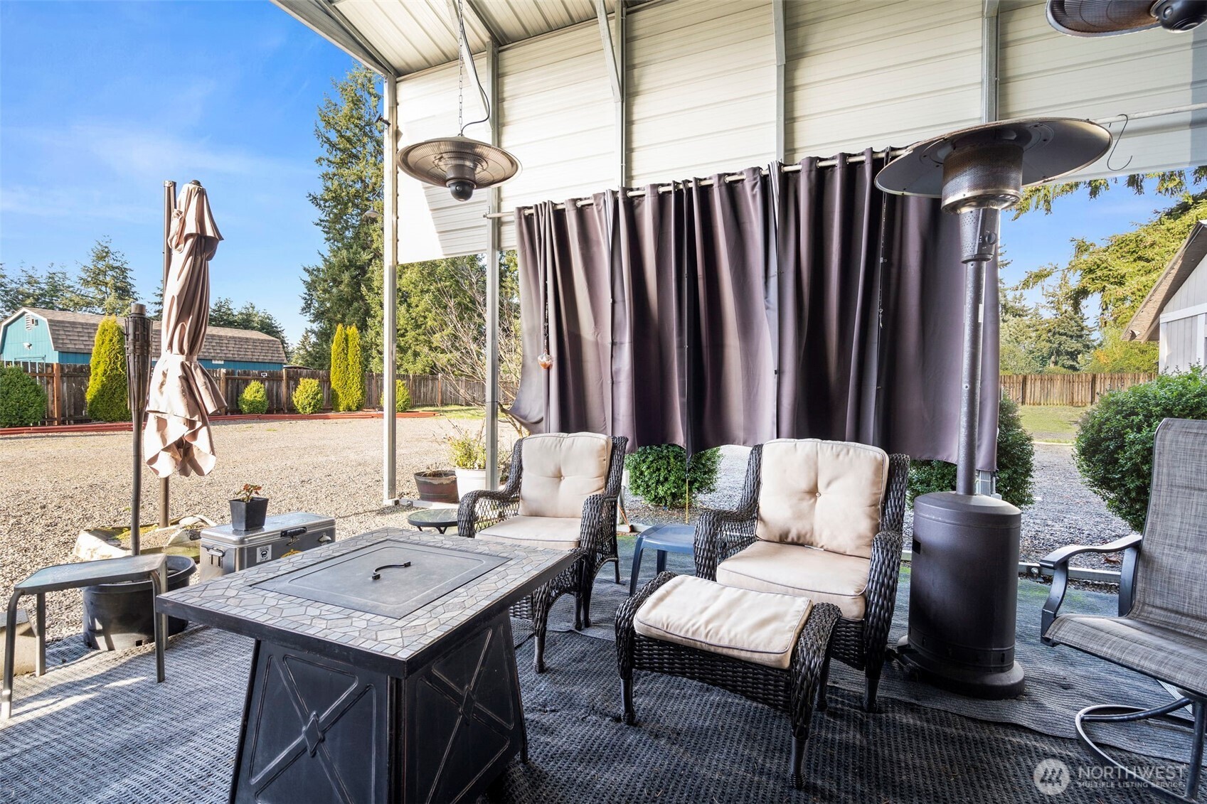 5916 187th Lane Southwest Rochester, WA 98579 - Photo 23 of 39 a view of a dinning tables and chairs in the patio