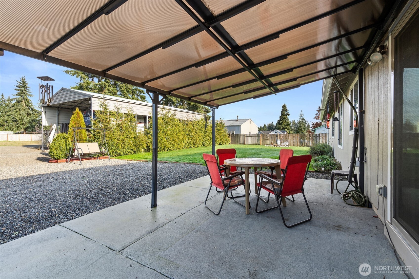 5916 187th Lane Southwest Rochester, WA 98579 - Photo 24 of 39 a view of a porch with furniture and a yard