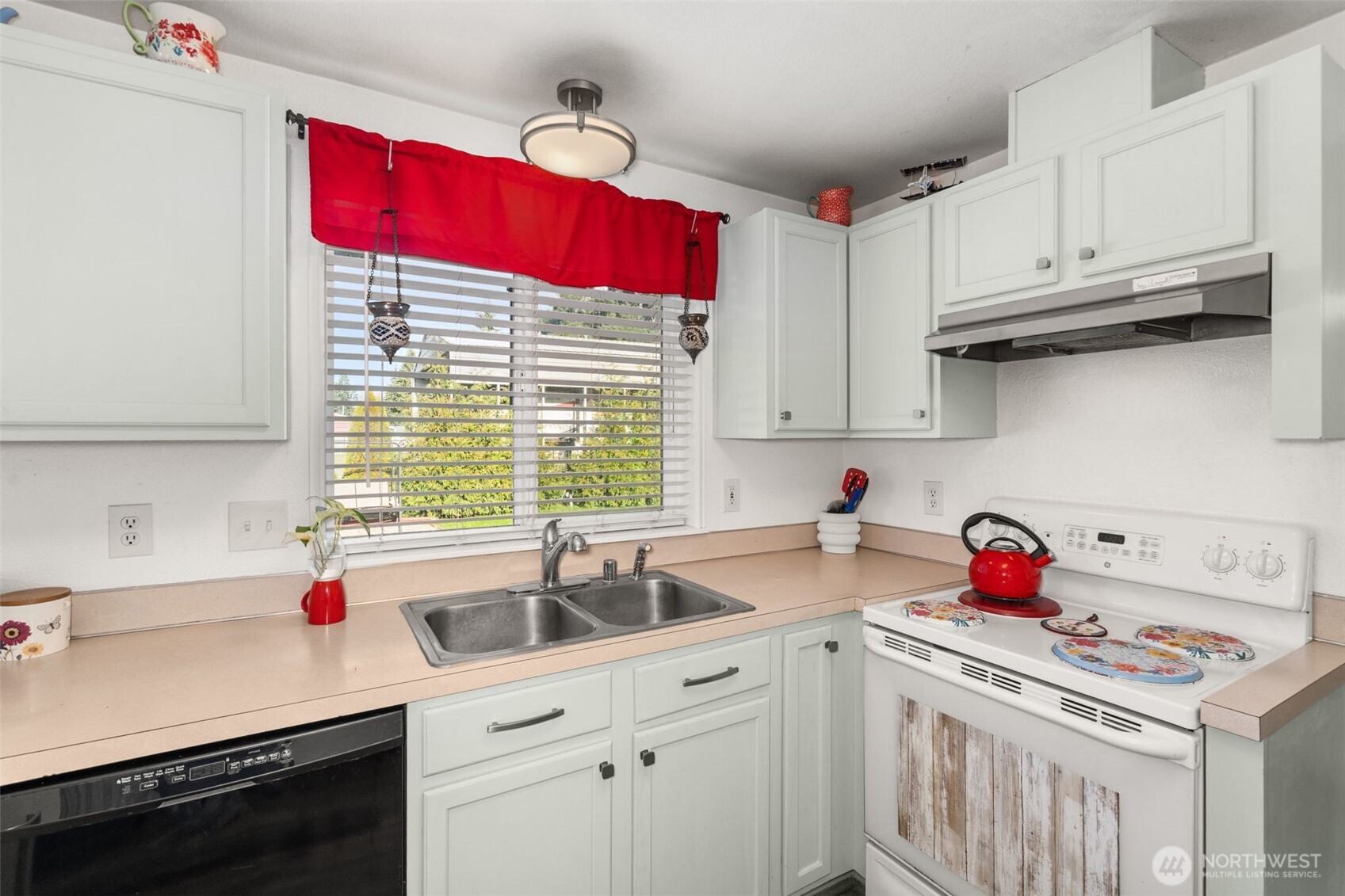 5916 187th Lane Southwest Rochester, WA 98579 - Photo 8 of 39 a kitchen with red cabinets a stove and window