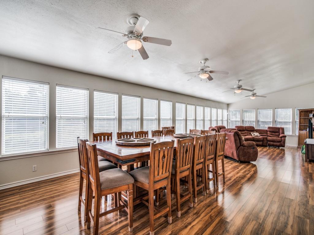 233 Esquire Estates Road Mabank, TX 75156 - Photo 12 of 34 Dining room featuring dark wood-style flooring, vaulted ceiling, ceiling fan, and a textured ceiling