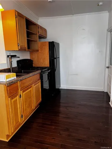 a room with wooden floor washer and dryer