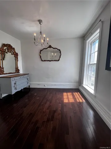 a view of a room with wooden floor and window