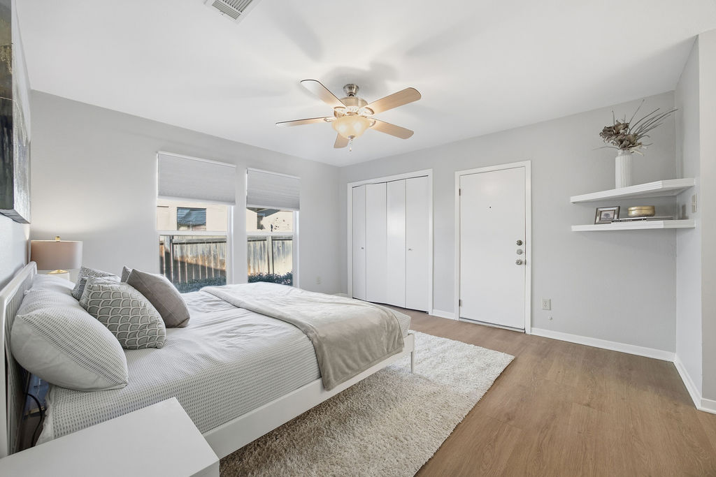 6486 Hart Lane Austin, TX 78731 - Photo 12 of 28 Bedroom featuring wood finished floors, a ceiling fan, and a closet